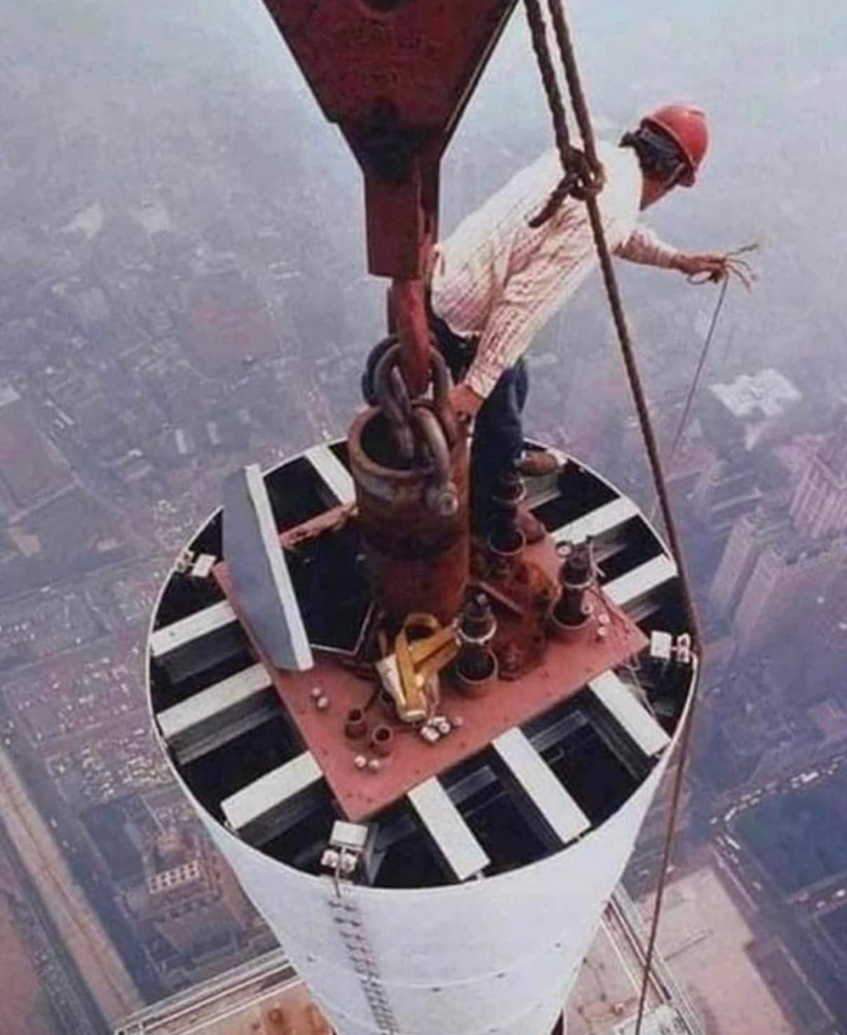 “A man repairs the antenna on the World Trade Center, NYC, 1979. Photo by Peter Kaplan.”